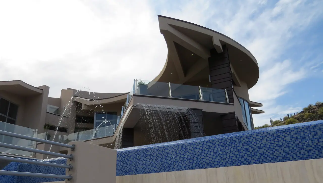 A building with a pool and water fall